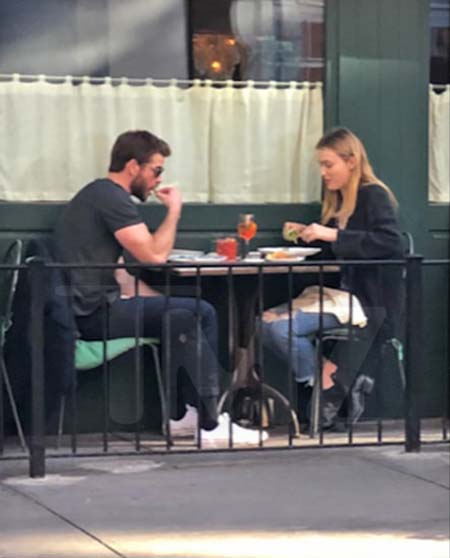 Liam and a girl sharing a meal while out.